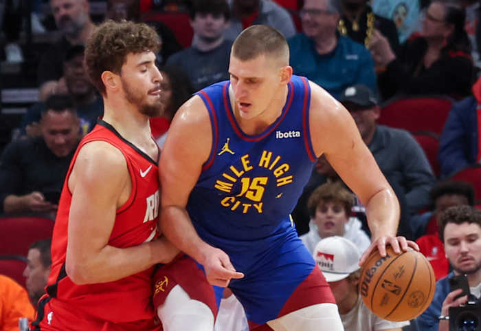 Nuggets center Nikola Jokic (15) dribbles against Houston Rockets center Alperen Sengun (28) in the first quarter at Toyota Center.